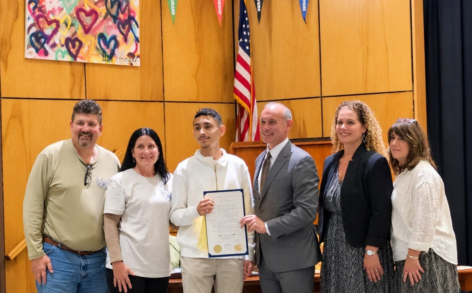 Phil and Mary Beth Kraese with Huntington High School senior Ronnie Jarama, Assemblyman Steve Stern and school staff